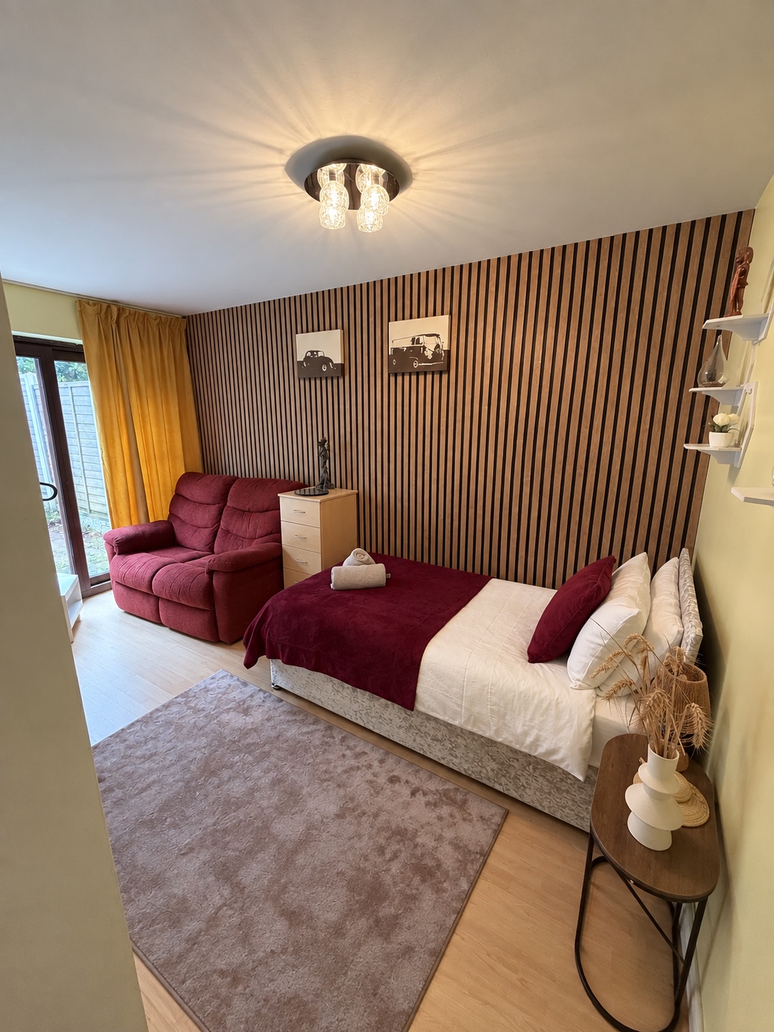 Ground-floor bedroom with single bed and armchair