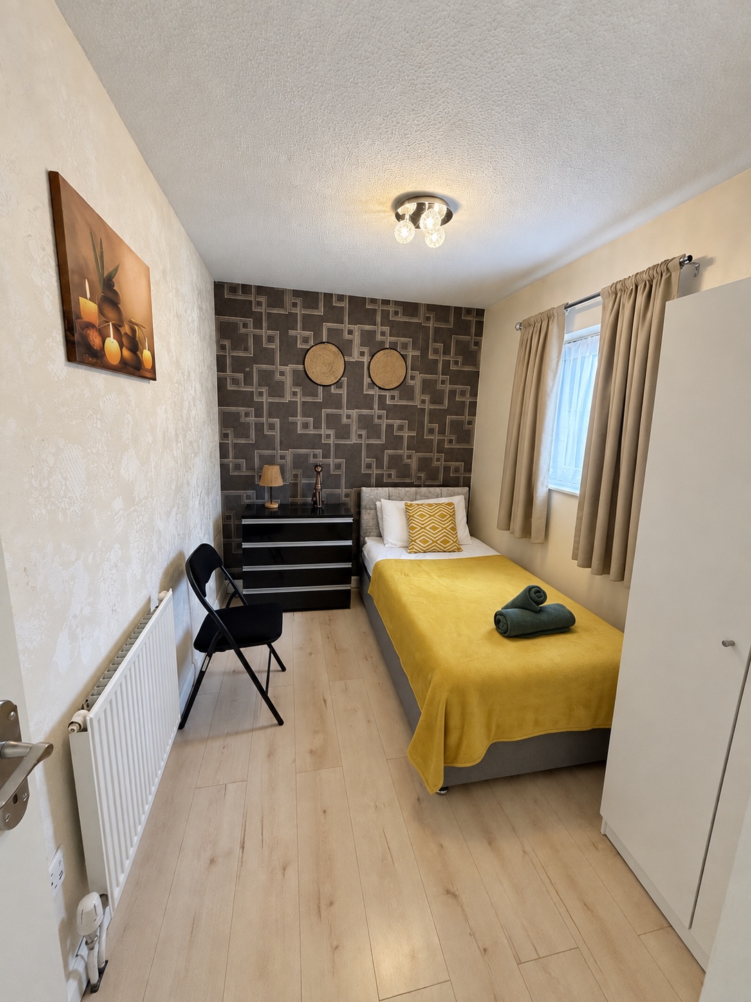 Single bedroom with yellow bedding